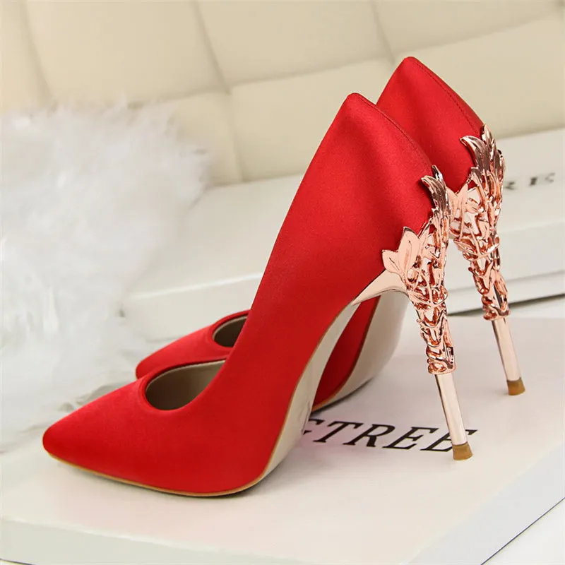 Pointy silver satin stiletto heels with 10cm heel and 1cm platform on neutral background