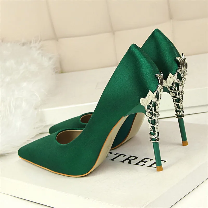 Pointy silver satin stiletto heels with 10cm heel and 1cm platform on neutral background