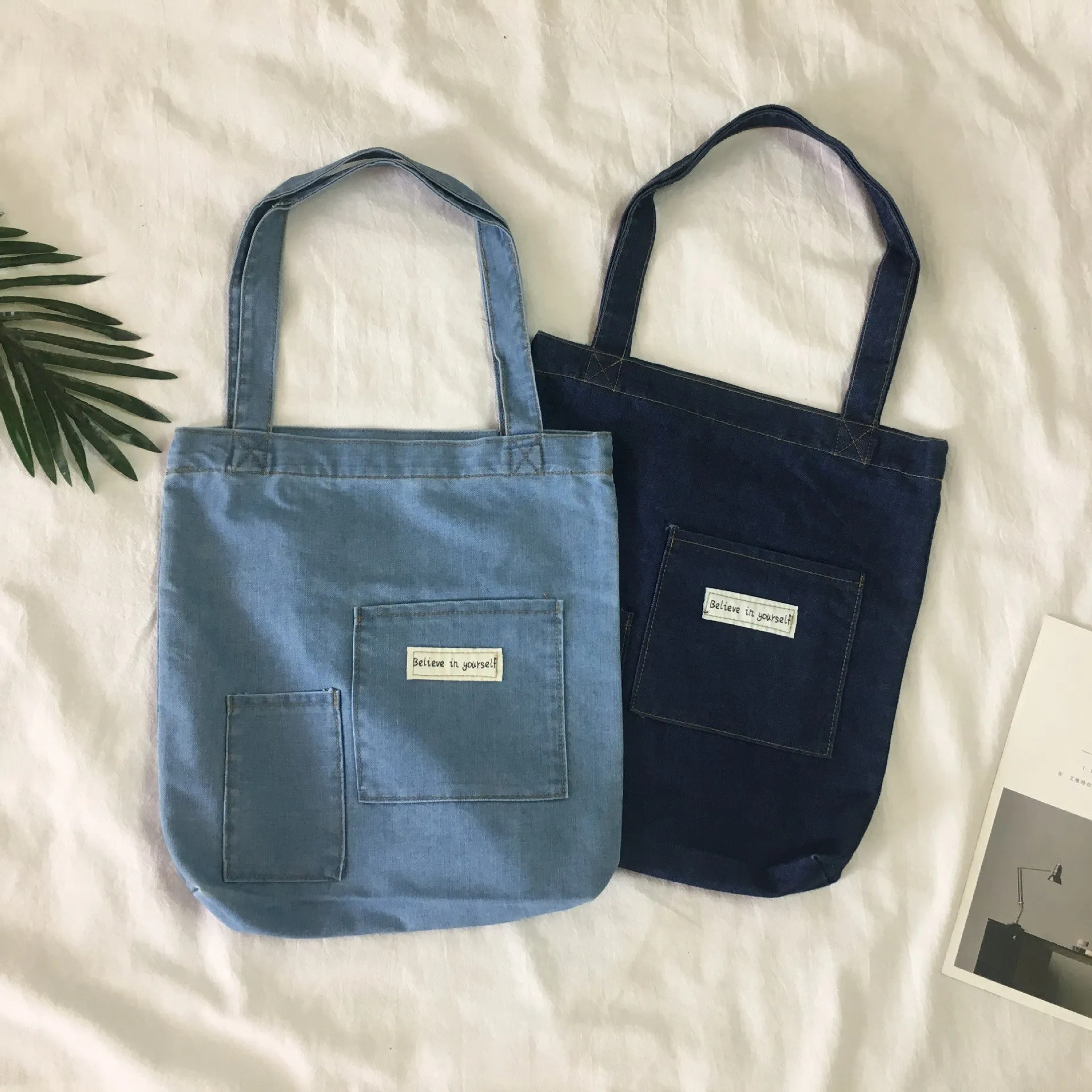 Shoulder bag with soft handle and inner patch pocket available in multiple colours including dark blue
