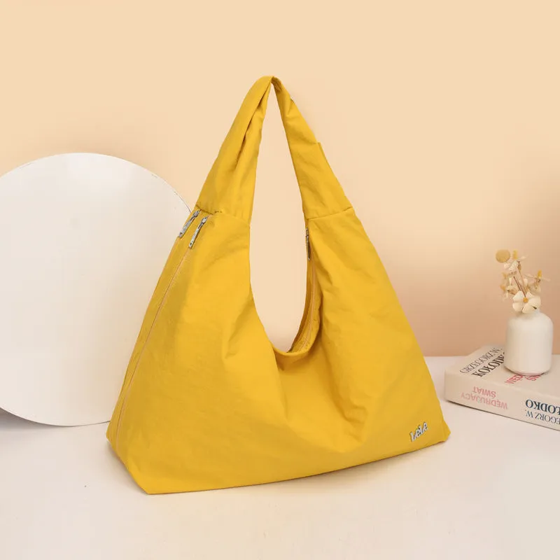 Soft heart-shaped nylon underarm bag for women shown in black, blue, khaki, and yellow.