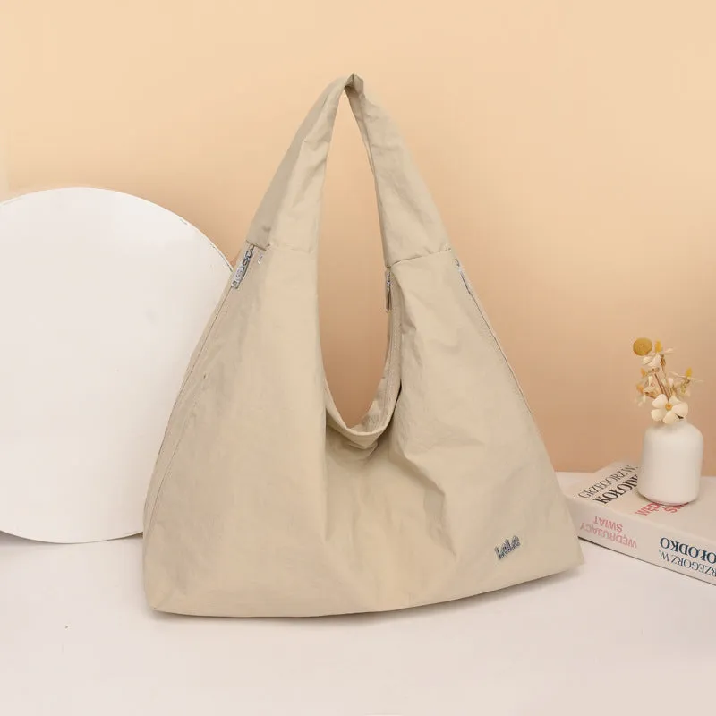Soft heart-shaped nylon underarm bag for women shown in black, blue, khaki, and yellow.
