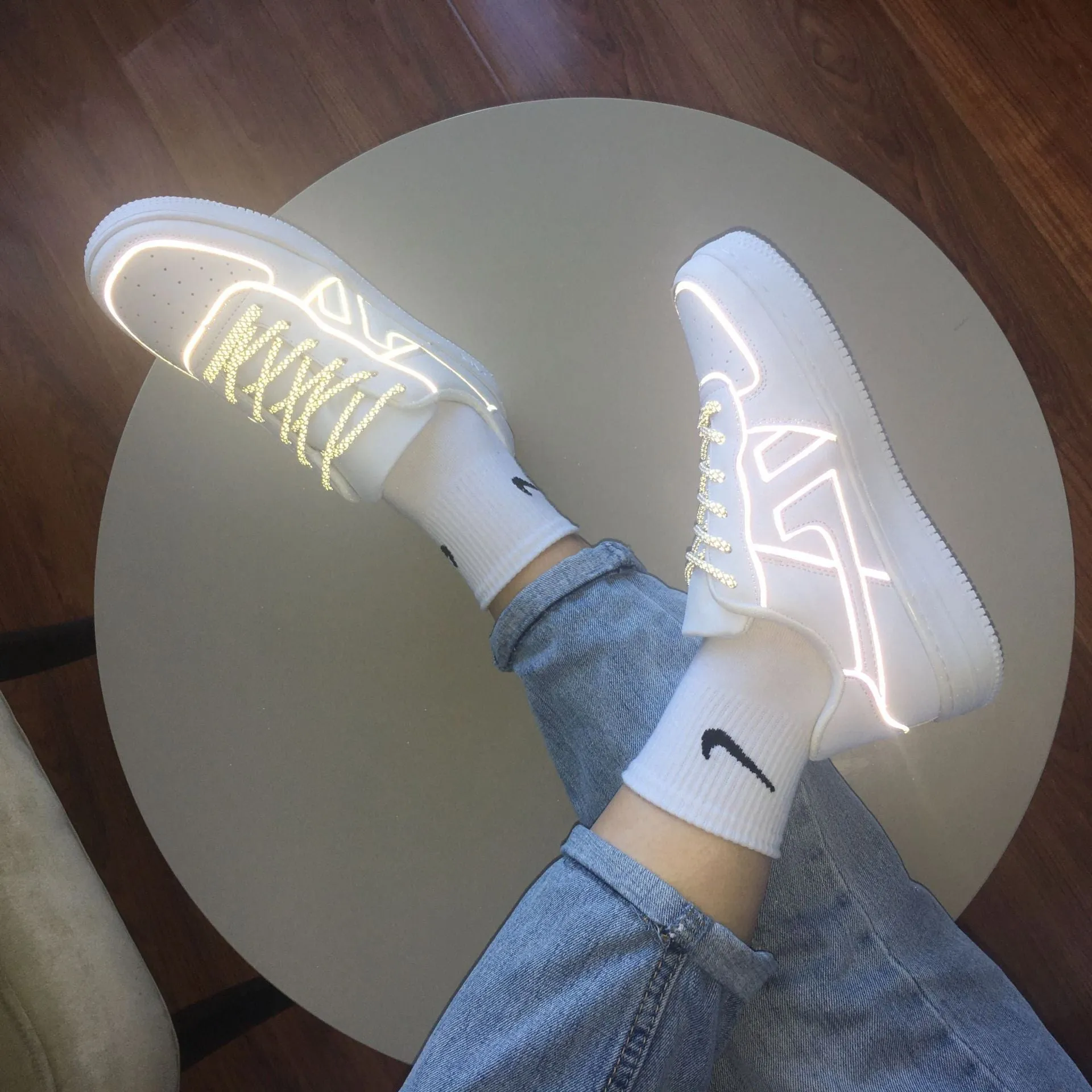 Reflective white unisex low top sneaker with lace up closure, synthetic leather upper, and TPR sole