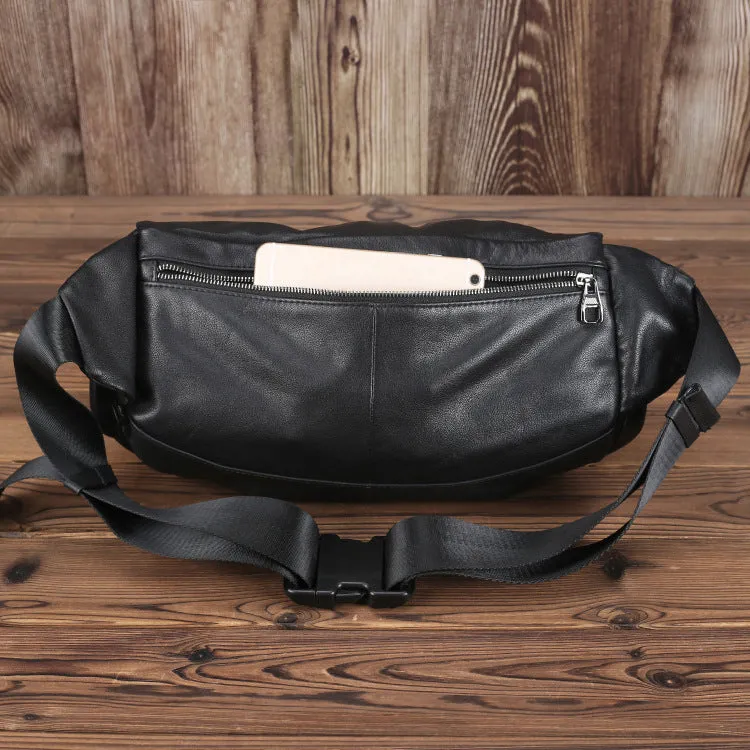 Black cowhide leather messenger bag with large capacity, oval shape, and zipper closure – worn over the shoulder as a crossbody bag