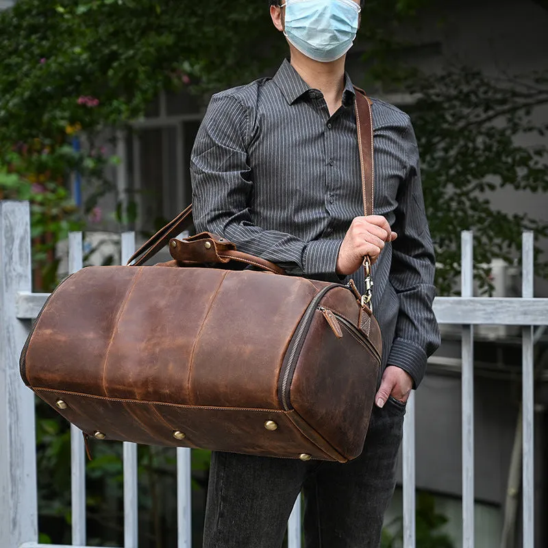 Vintage 22 inch brown leather duffle bag made from top layer cowhide, folding design with zipper closure on plain background