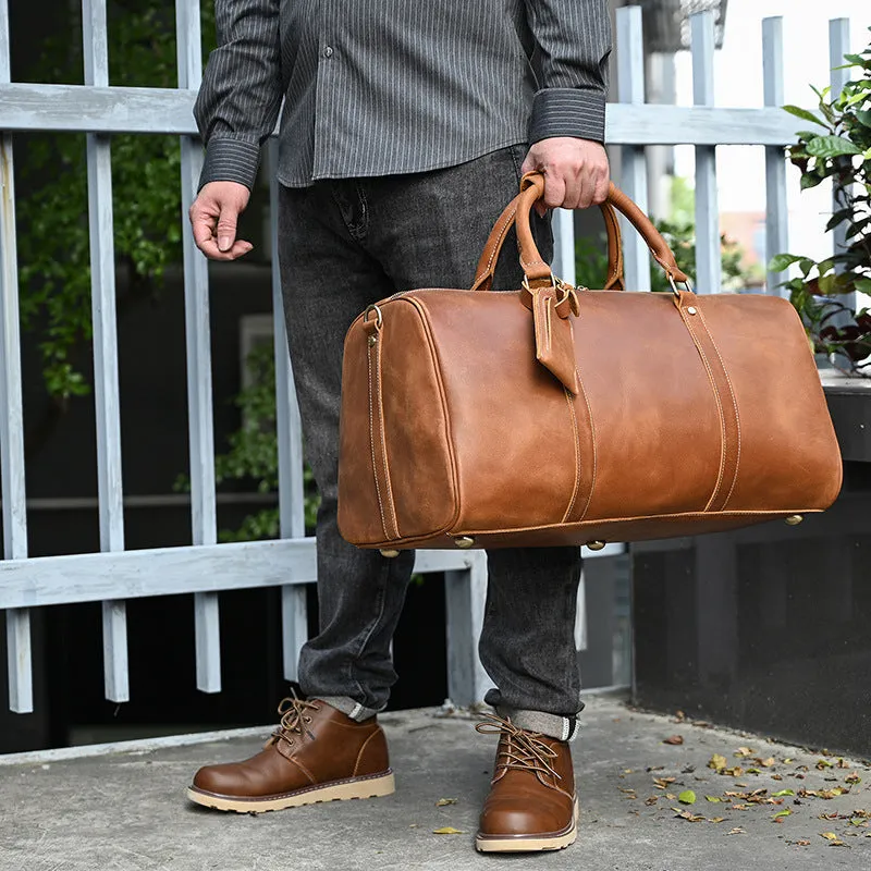 Vintage 22 inch brown leather duffle bag made from top layer cowhide, folding design with zipper closure on plain background