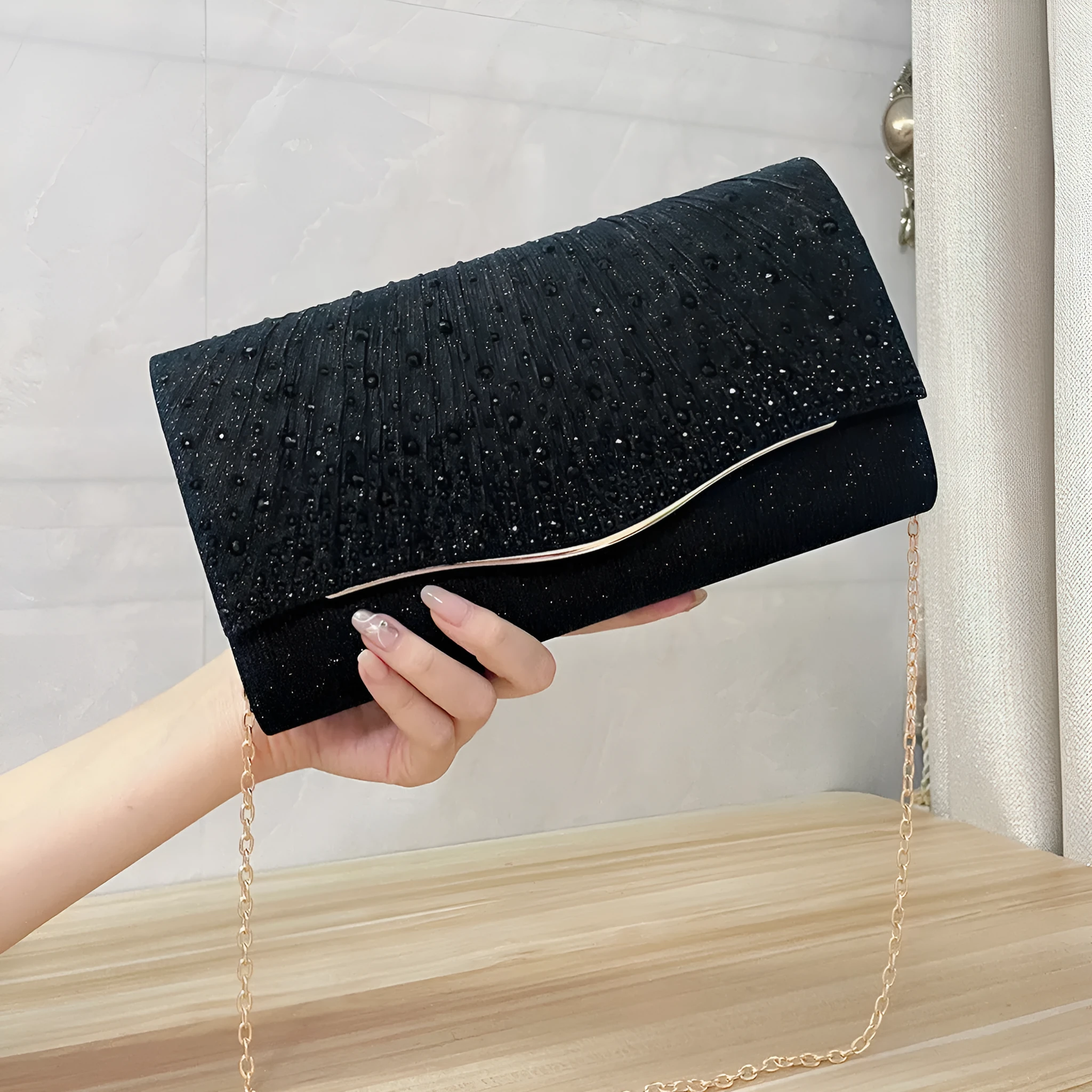 Women's dinner clutch bag in woven fabric with rhinestone dress garment design, available in black, champagne, and silver