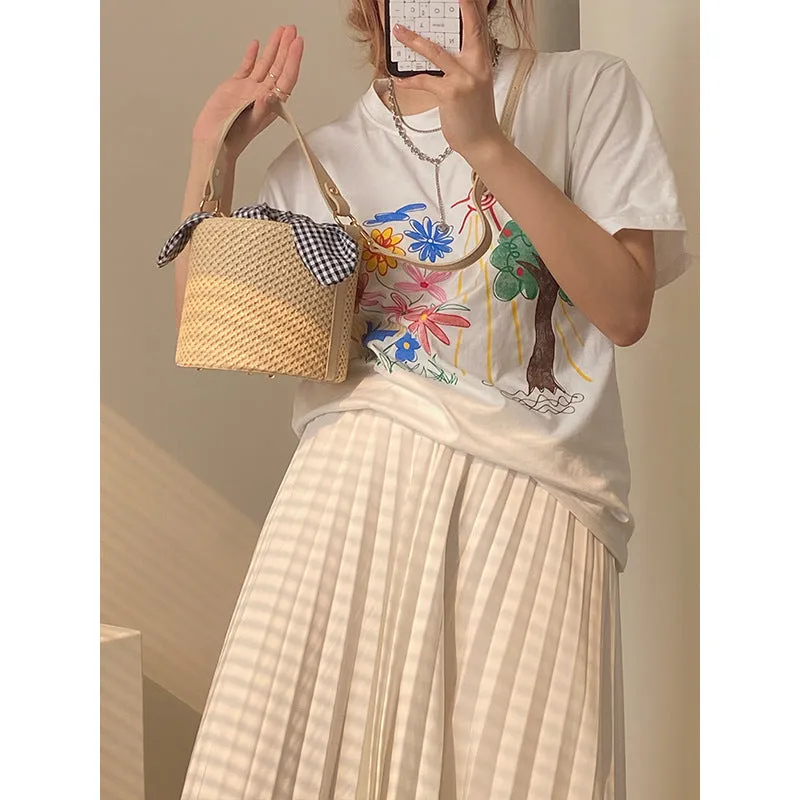 Women's medium beige PU bucket straw bag with open top and messenger strap on neutral background