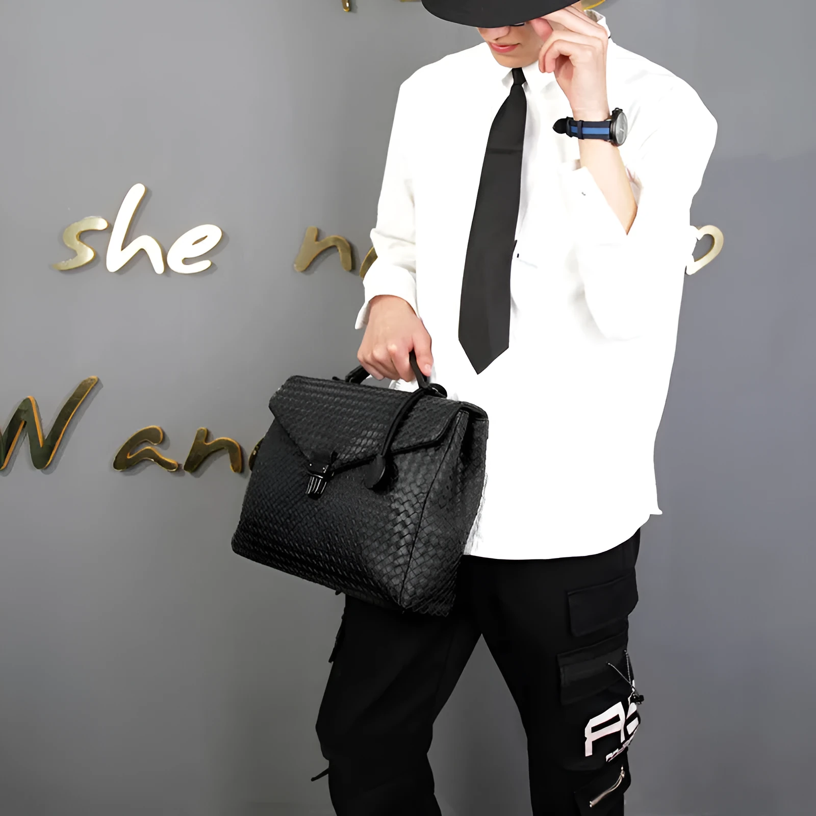 Men's handbag in black super fibre synthetic leather with clamshell knitting pattern, horizontal square shape, latch closure, and soft handle