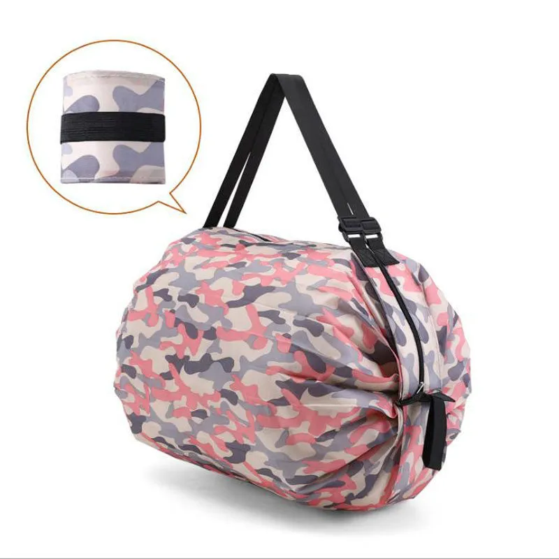 Foldable large-capacity shopping bag in 210d Oxford cloth with pink camouflage colour, hanging on a wall hook