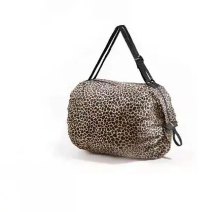 Foldable large-capacity shopping bag in 210d Oxford cloth with pink camouflage colour, hanging on a wall hook