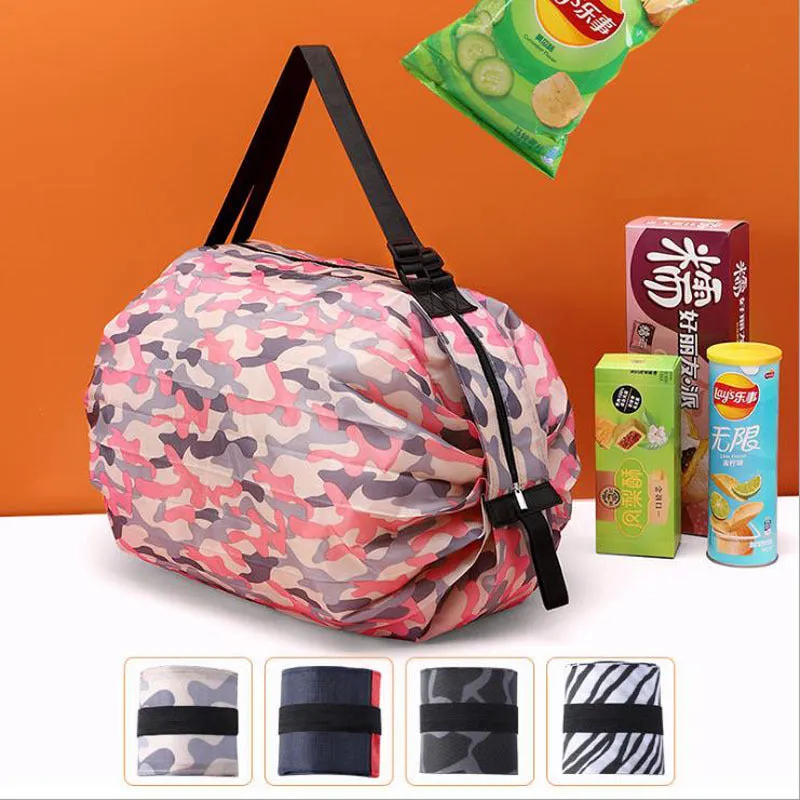 Foldable large-capacity shopping bag in 210d Oxford cloth with pink camouflage colour, hanging on a wall hook