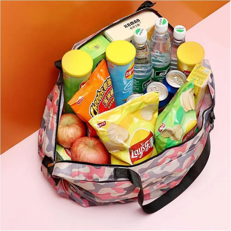 Foldable large-capacity shopping bag in 210d Oxford cloth with pink camouflage colour, hanging on a wall hook