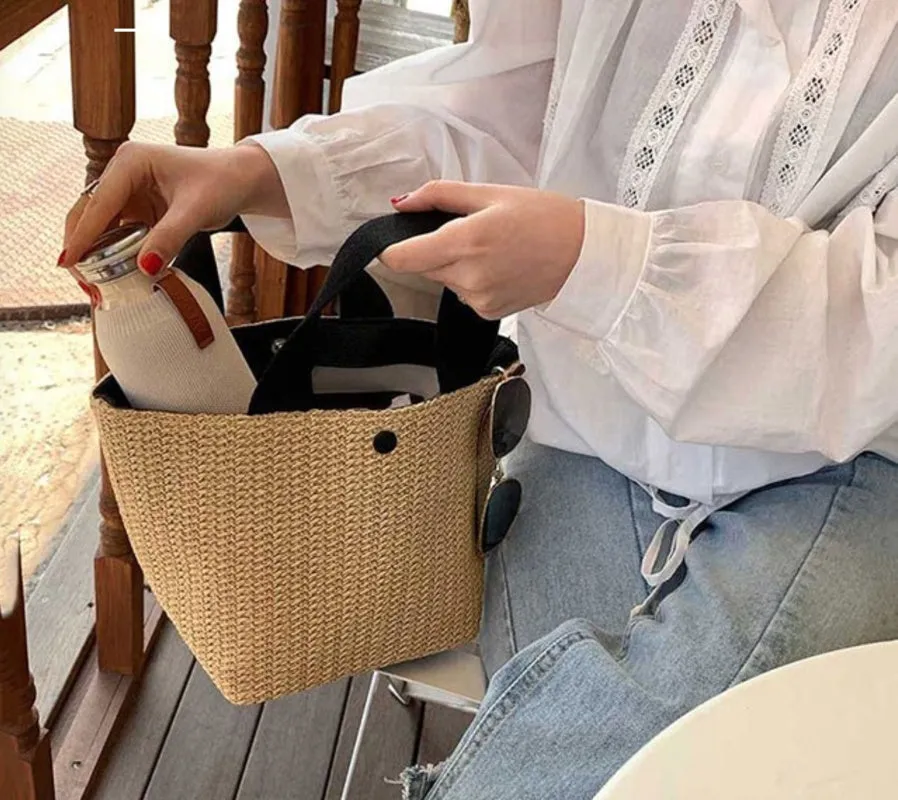 Casual rattan straw shoulder bag in black, bucket shape with shoulder strap