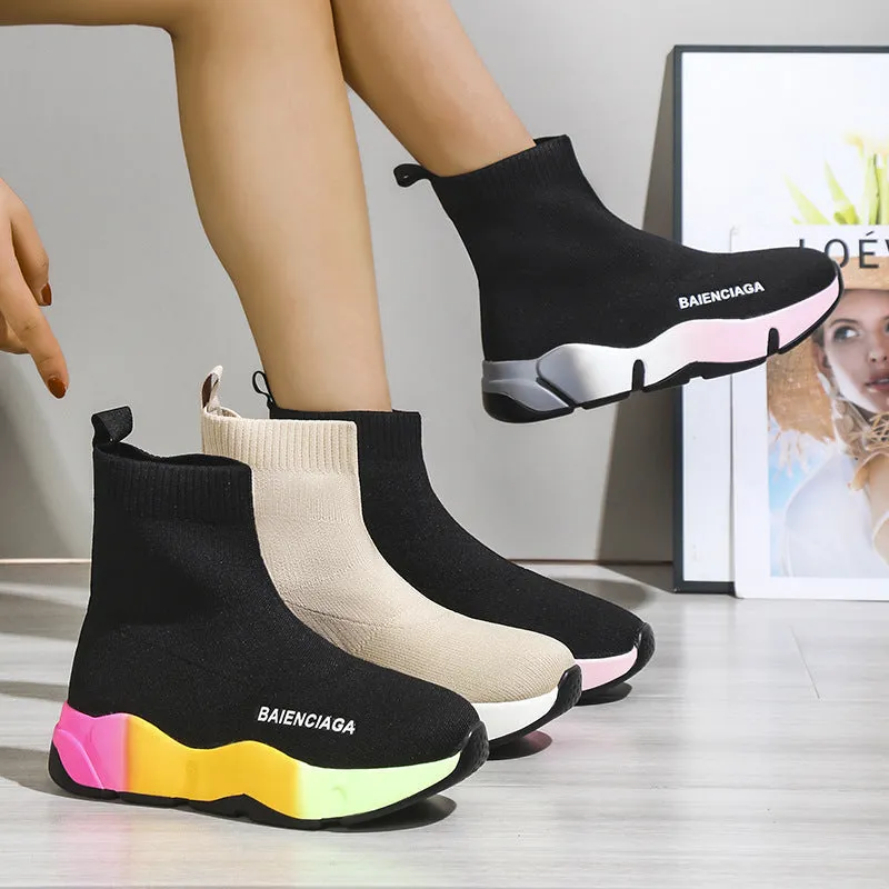 Women's black platform sock boots with cloth upper, rubber sole, round toe, thick heel, and low tube design on a neutral background