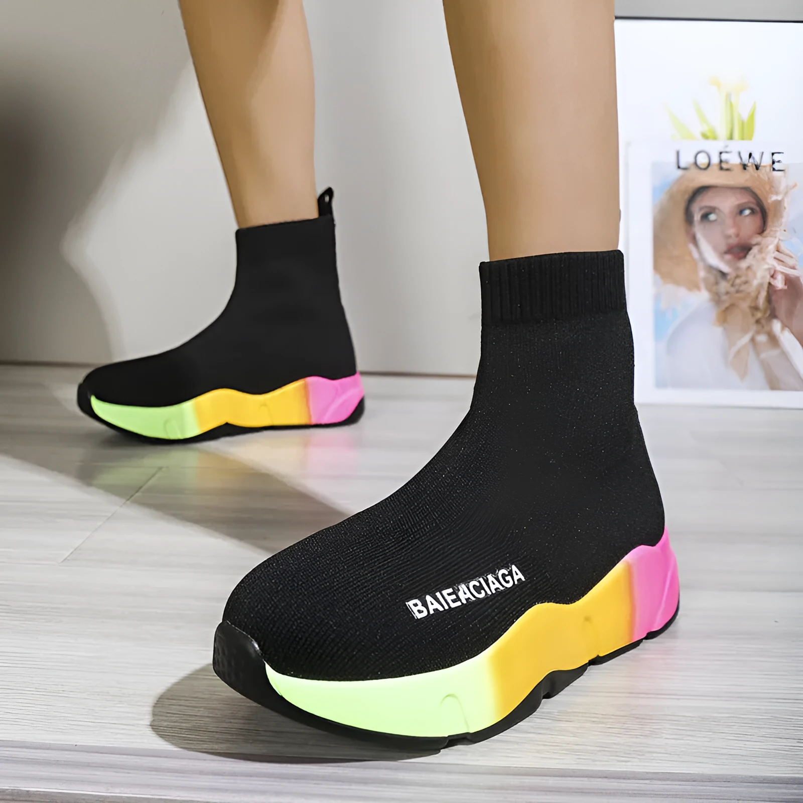 Women's black platform sock boots with cloth upper, rubber sole, round toe, thick heel, and low tube design on a neutral background
