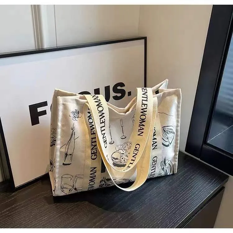 Large women's canvas tote bag with printed design, shown in available colour options.