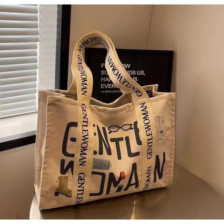 Large women's canvas tote bag with printed design, shown in available colour options.