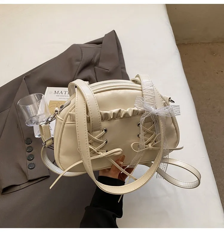 Women's casual PU shoulder handbag with a large bandage bow detail and phone compartment.