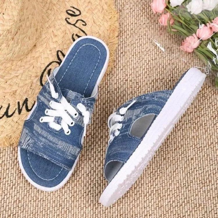 Blue women's Roman-style flat canvas slippers with a cloth upper and rubber sole.