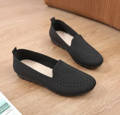Women's casual flat shoes in black with breathable slip-on design