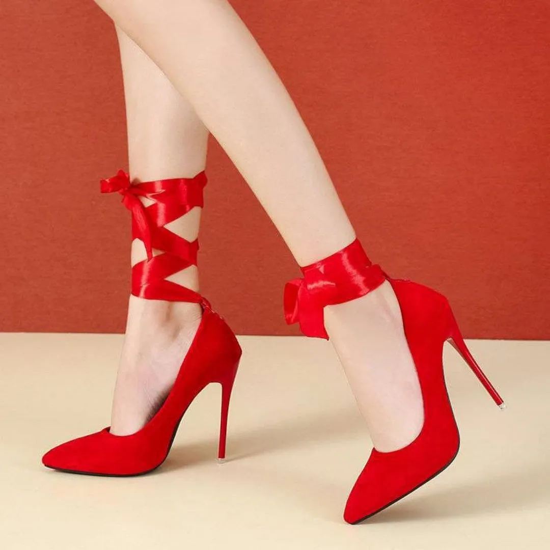 Women's black platform court shoe with pointed toe and lace ankle strap on a 12cm heel.