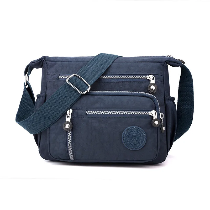 Nylon messenger shoulder bag in square vertical shape shown in light blue colour.