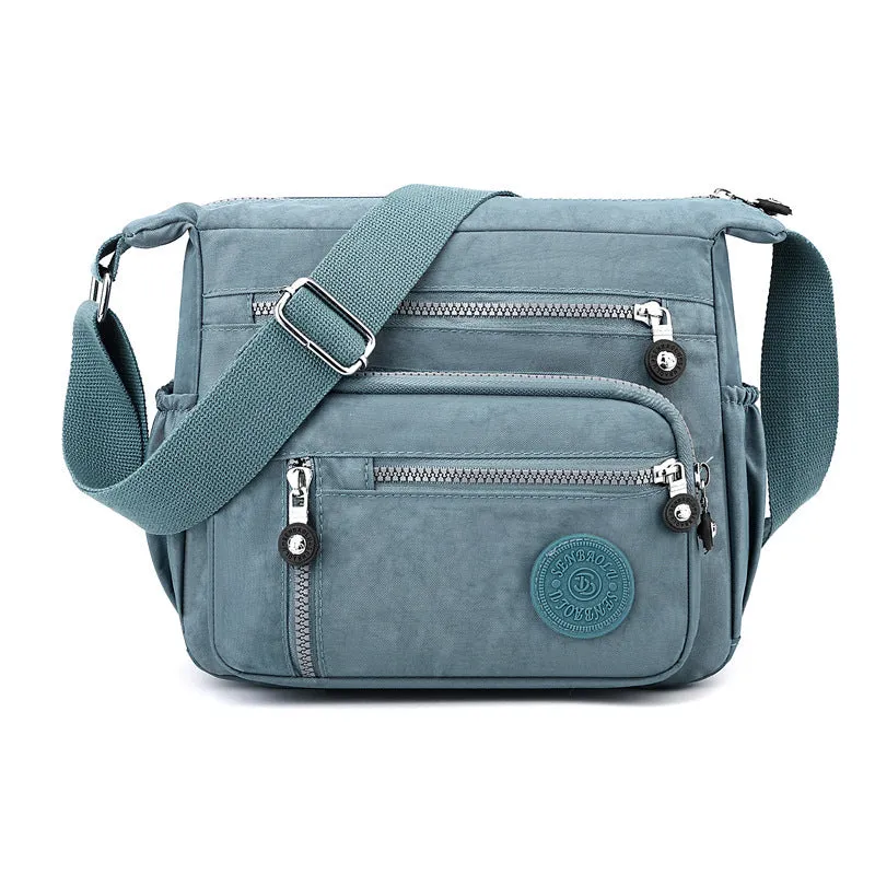 Nylon messenger shoulder bag in square vertical shape shown in light blue colour.