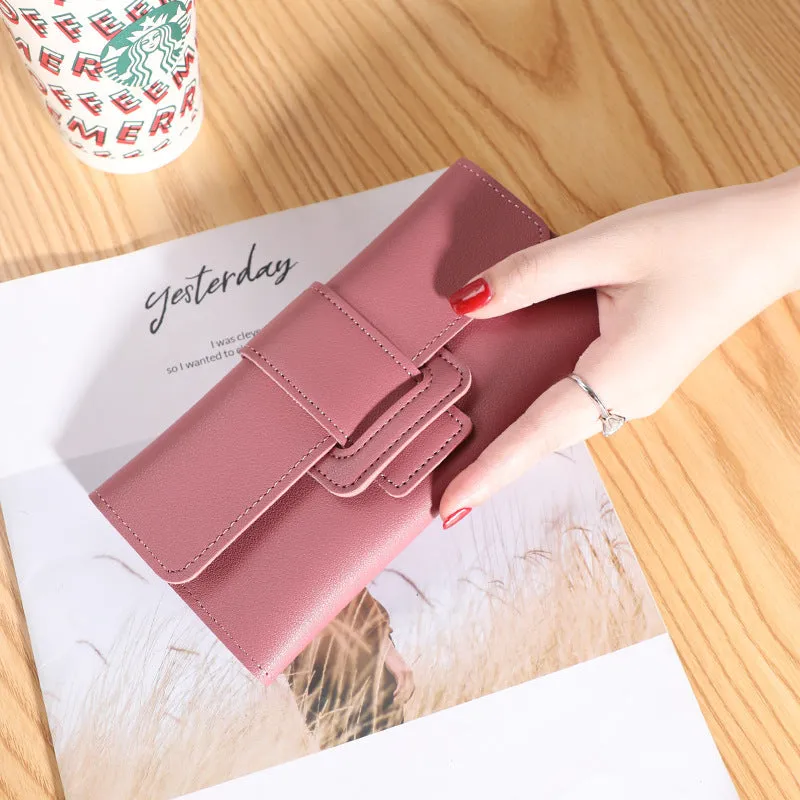 Women's long tri-fold wallet in light grey PU leather with sewing thread detail, open to show multiple card slots and cash compartments.