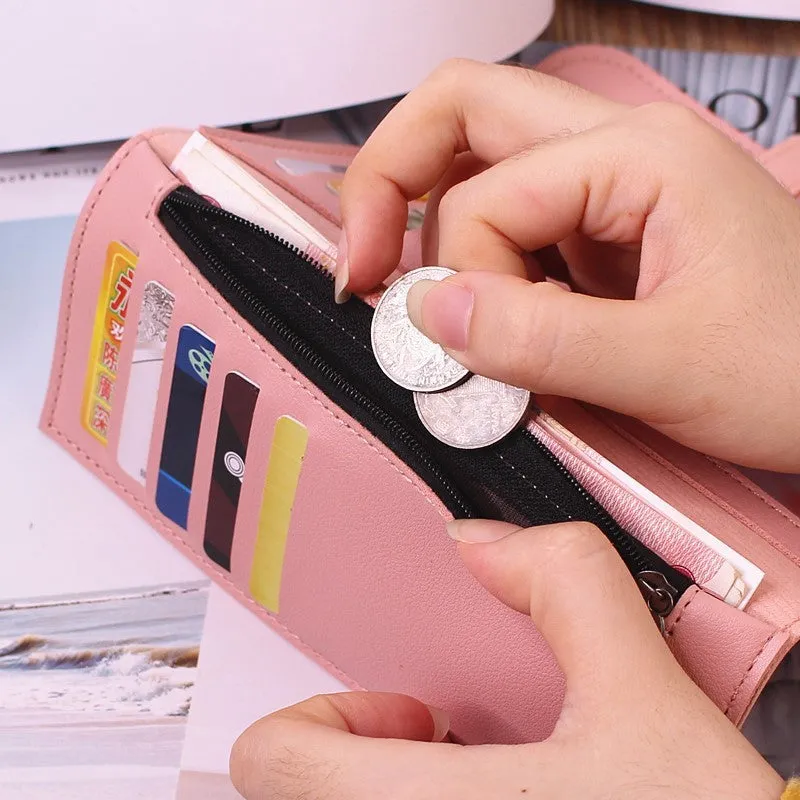 Women's long tri-fold wallet in light grey PU leather with sewing thread detail, open to show multiple card slots and cash compartments.