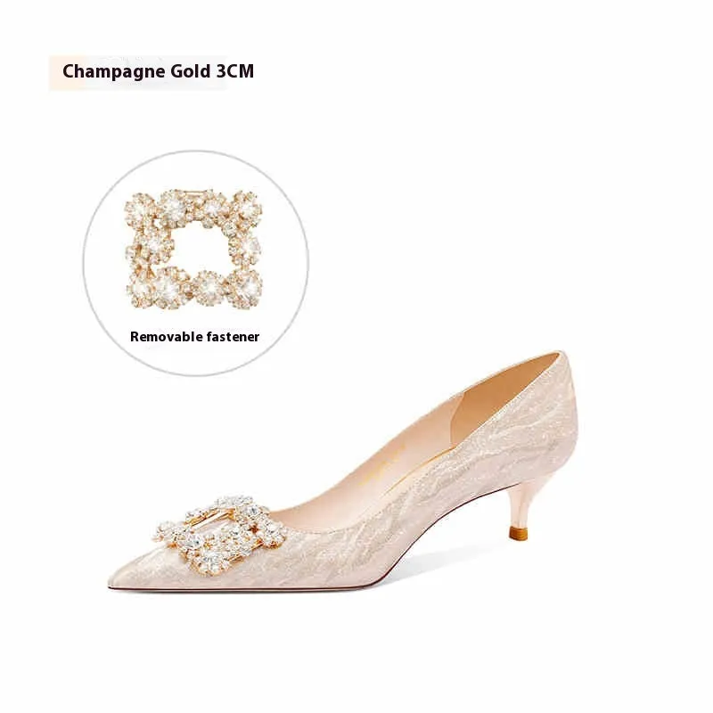 Champagne gold pointed-toe stiletto pumps with rhinestone details on the heel.
