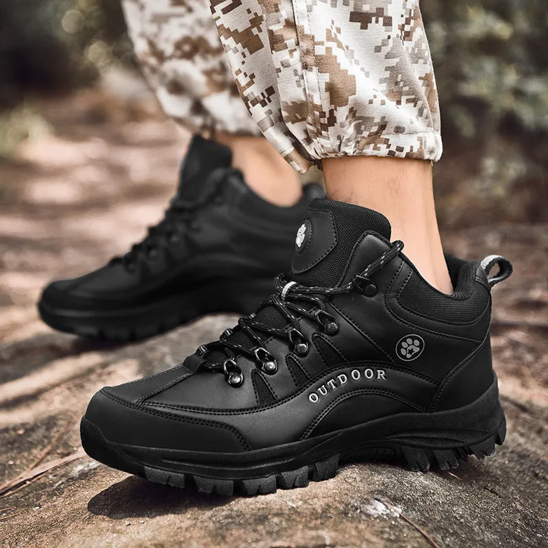 Men's military-style hiking boots in black with PU upper and rubber sole, shown on outdoor ground.