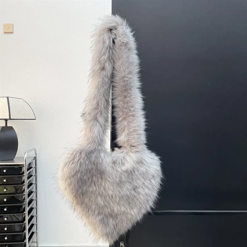 Women winter fleece heart shape crossbody bag with plush exterior, tassel detail, and large capacity