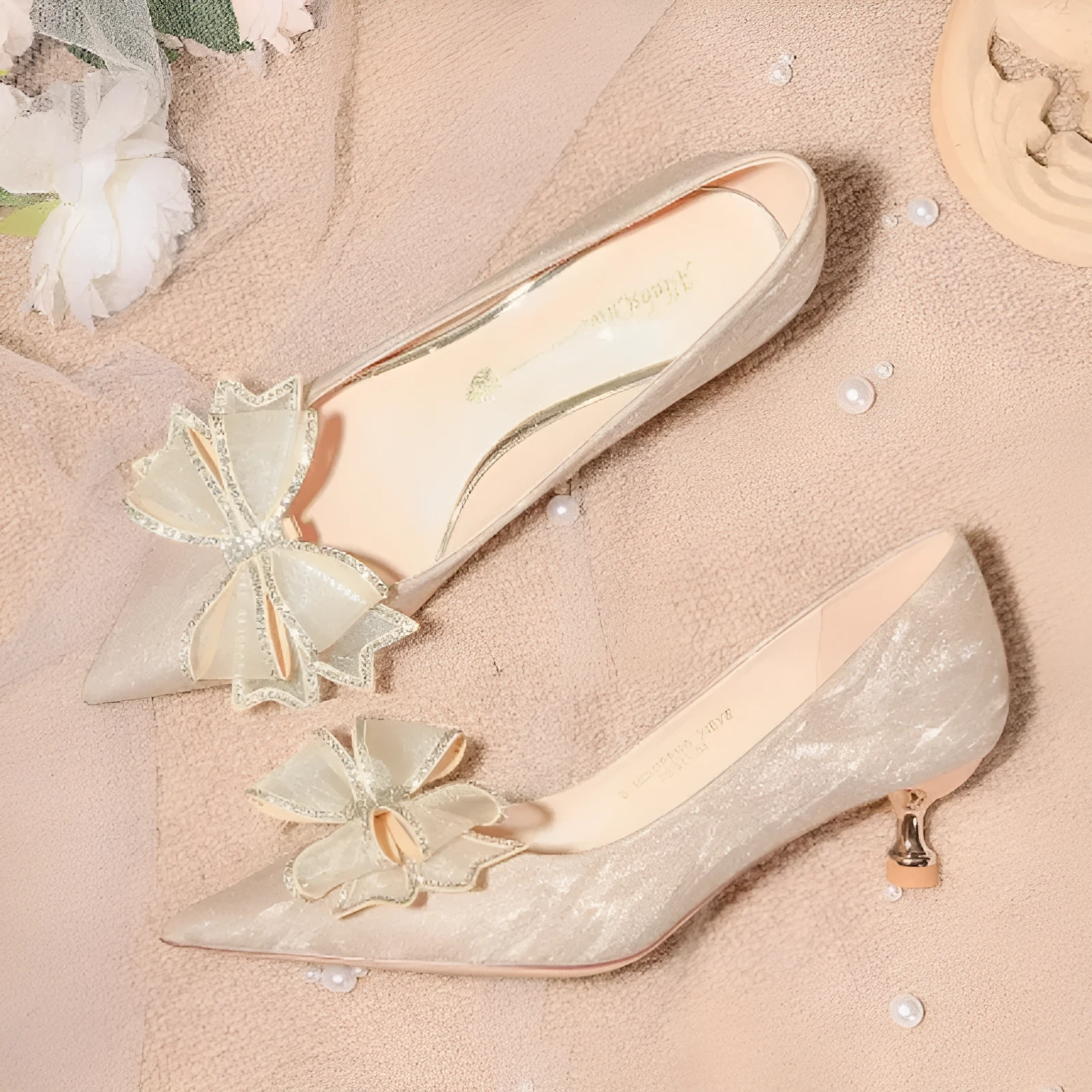 Women's champagne gold sequined pointed stiletto heel pumps for weddings, shown on a plain background.