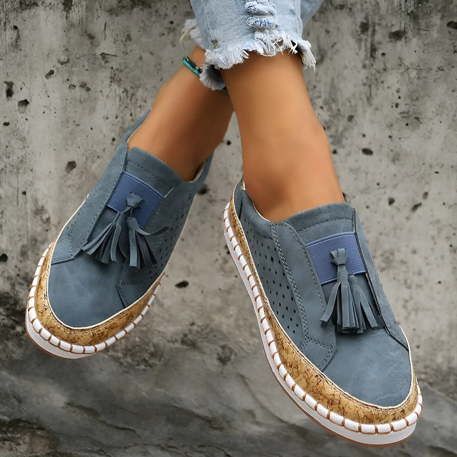 Women's tassel flats loafers in black with round toe, low heel, and cross strap detail
