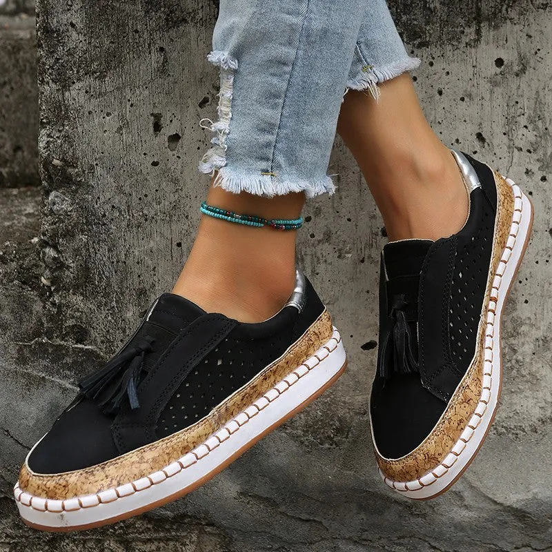 Women's tassel flats loafers in black with round toe, low heel, and cross strap detail