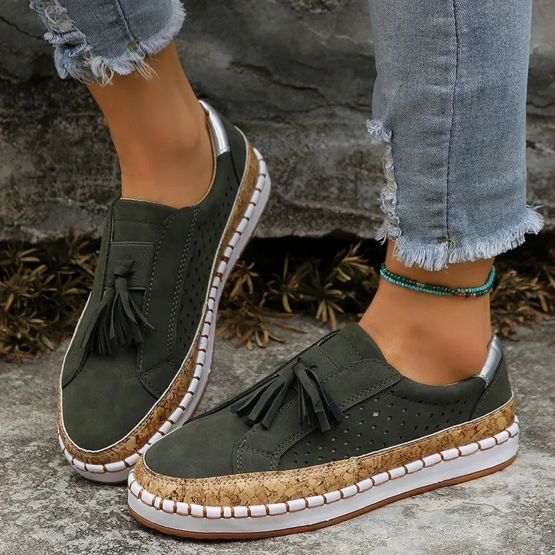 Women's tassel flats loafers in black with round toe, low heel, and cross strap detail