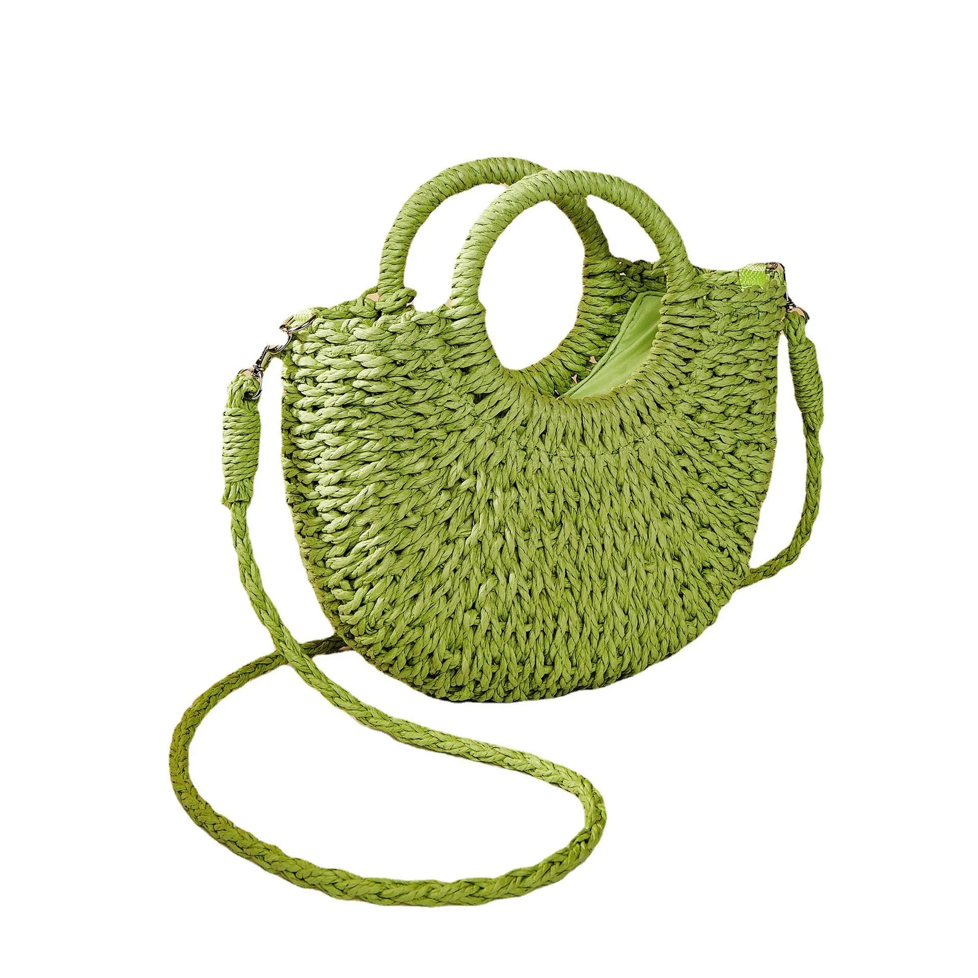 Woven straw beach bag in beige, peach skin lining, crossbody style, 24cm height, on a sandy beach