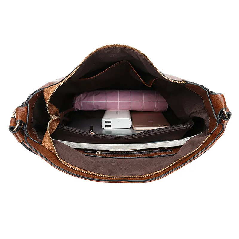 Hobos zipper bucket bag in black with adjustable shoulder strap on a woman's shoulder