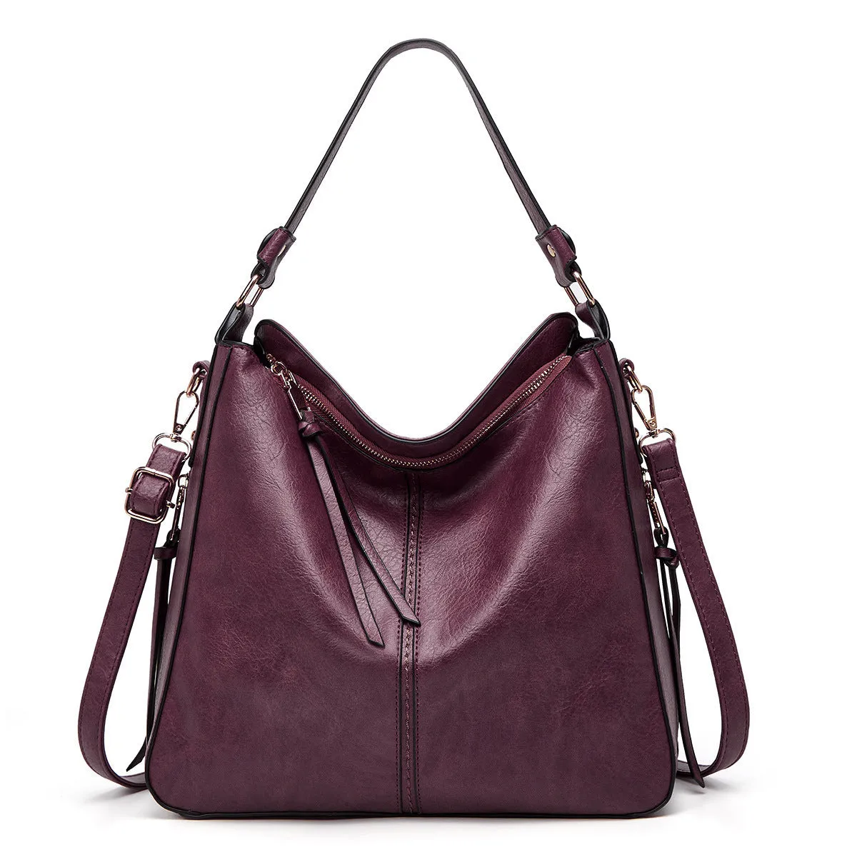 Hobos zipper bucket bag in black with adjustable shoulder strap on a woman's shoulder