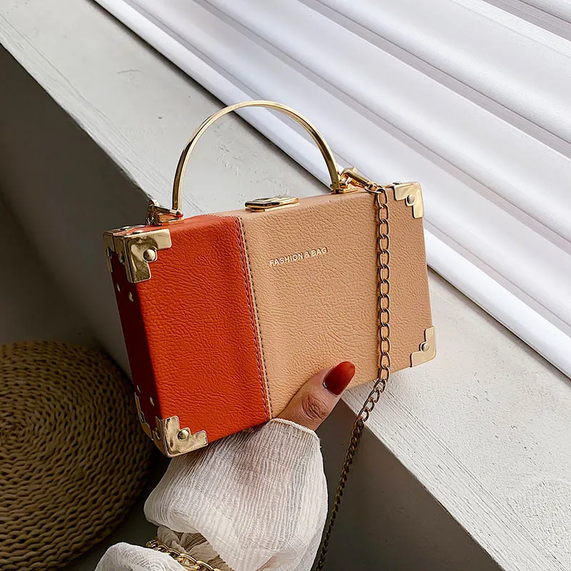 Ladies party clutch bag in orange with box handle and long chain, PU artificial leather, 19x5x12cm