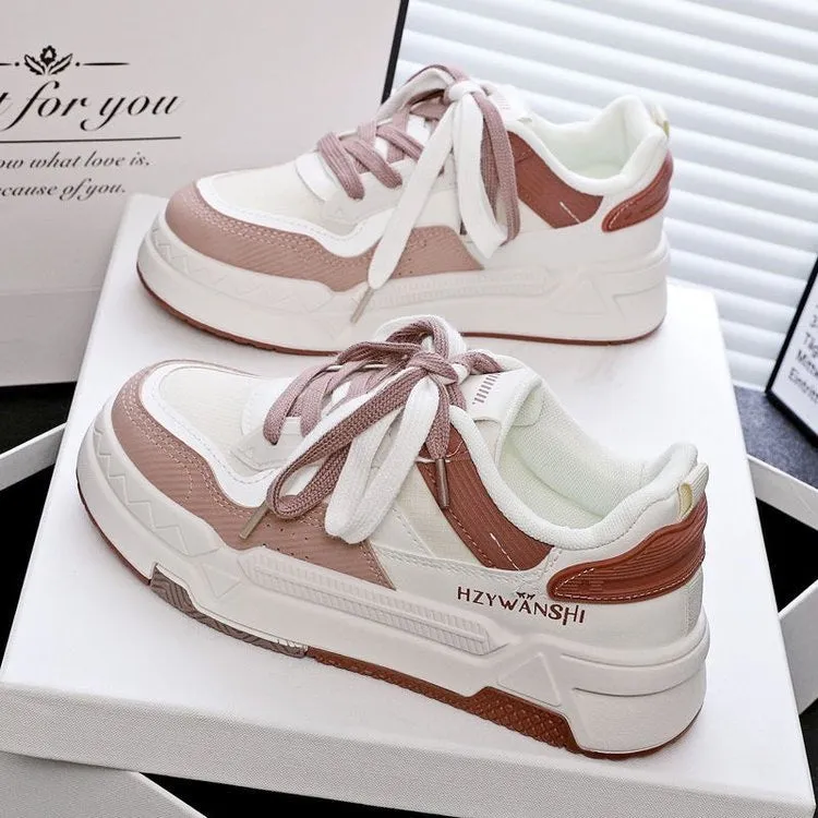 Children's beige platform trainers with cross-strap design over laces and a thick rubber sole.