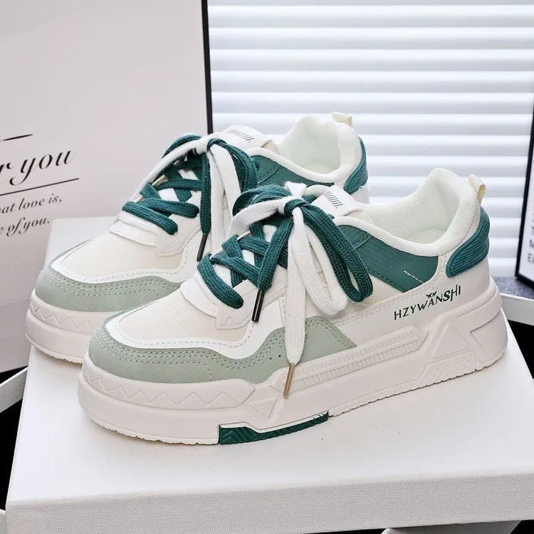 Children's beige platform trainers with cross-strap design over laces and a thick rubber sole.