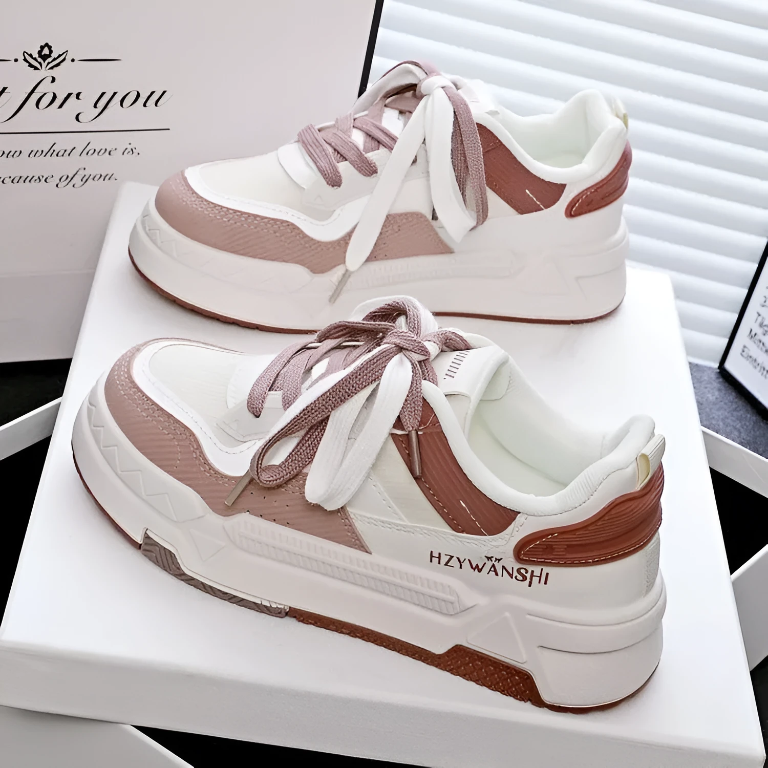 Children's beige platform trainers with cross-strap design over laces and a thick rubber sole.