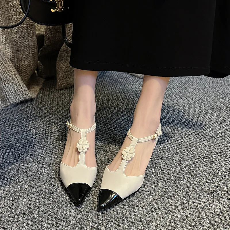 Women's gold stiletto shoe with flower decoration and buckle on sheepskin upper.