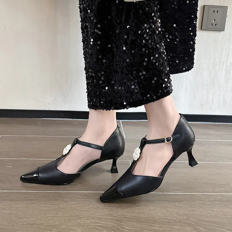Women's gold stiletto shoe with flower decoration and buckle on sheepskin upper.