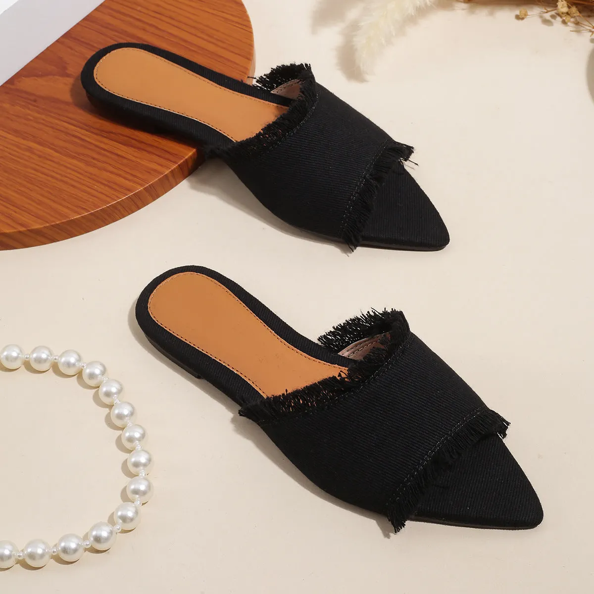 Women's flat denim slippers with a tassel detail in apricot colour on a white background