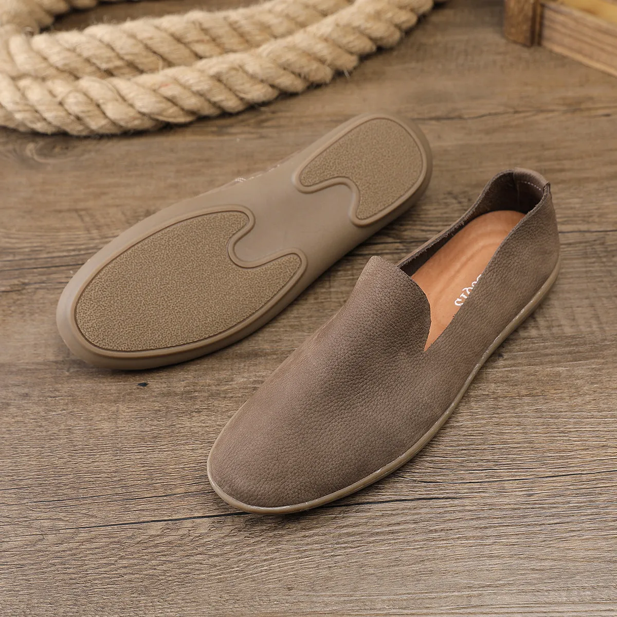 Handmade low top men's shoes in khaki or grey with a flat wedge heel and rubber sole.