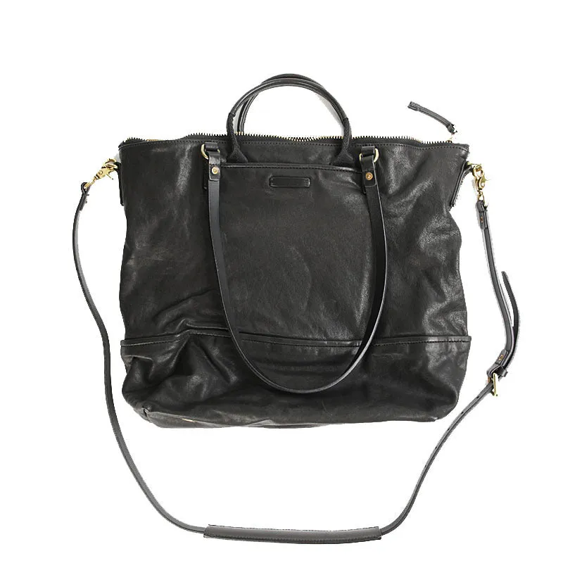 Black handmade vegetable tanned cowhide tote bag with zipper closure and 15-inch computer slot for daily outdoor use