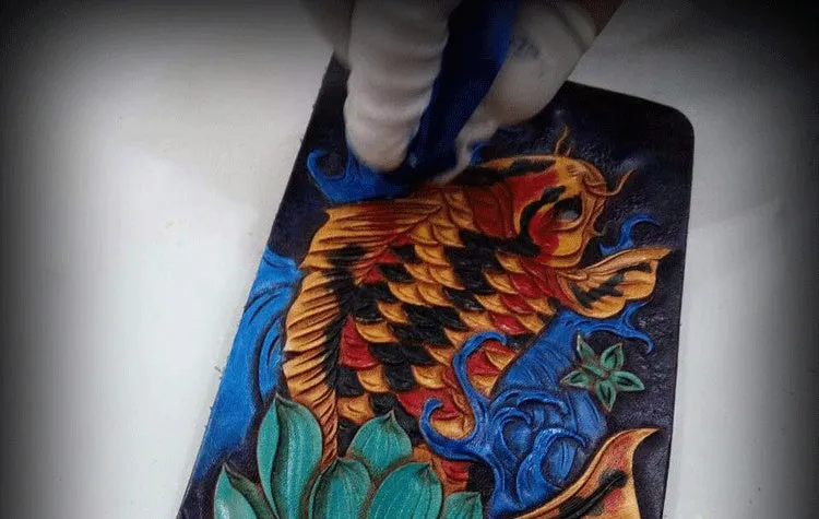 Men's carved cow leather short wallet in blue, showing open foldover design and dimensions.