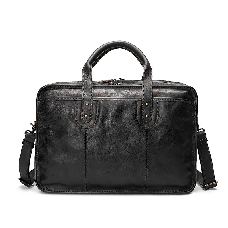 Men's vintage brown leather briefcase open to show internal laptop and camera pockets.